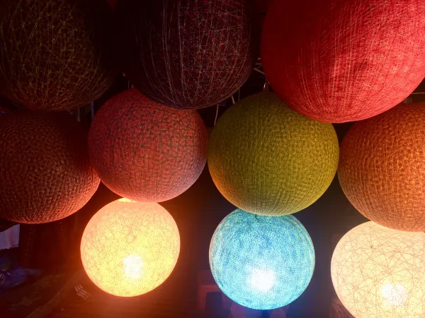 Colorful handmade lanterns in Luang Prabang, Laos, showcasing vibrant hues and intricate designs, perfect for a cozy atmosphere and local craft shopping.